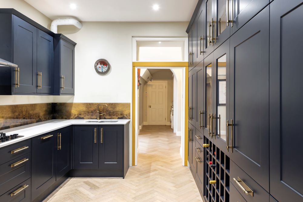 A new kitchen was installed with quartz worktops, a Chelford navy customised kitchen, Quooker classic fusion square patinated brass hot taps and parquet flooring.